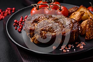 Delicious juicy pork or beef steak grilled with salt, spices and herbs