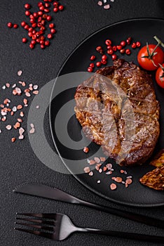 Delicious juicy pork or beef steak grilled with salt, spices and herbs