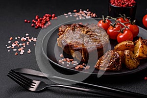 Delicious juicy pork or beef steak grilled with salt, spices and herbs