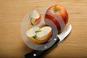 Delicious juicy red apple sliced and knife