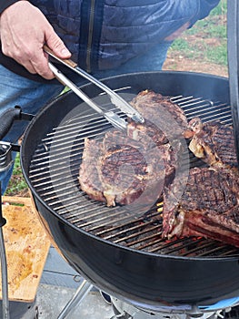 Delicious juicy Ribeye steak on the bone on the grill. Grilled tibon steak