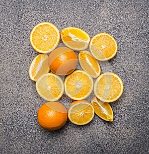 Delicious, juicy, ripe oranges, sliced granite rustic background top view close up