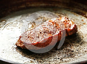 Delicious juicy steak on frying pan
