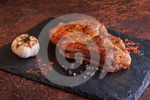 Delicious and juicy steak surrounded by spices.  Lying on a stone tray