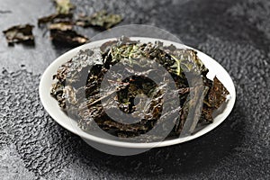 A delicious Kale chips, snack on white plate. Healthy vegetable food.