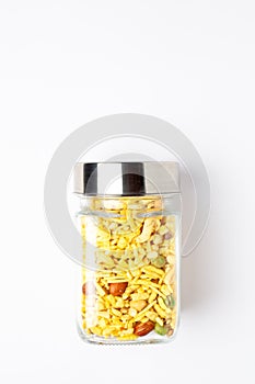 Delicious Khatta-Meetha in a glass jar lid closed, made with peanuts, sugar, raisins, and besan sev