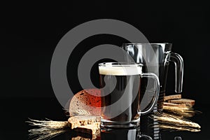 Delicious kvass, bread and spikes on black background. Space for text