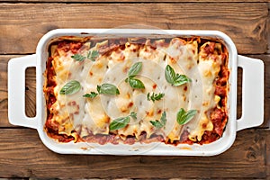 Delicious lasagna in a baking dish on a wooden background. Lasagna in a baking dish, top view