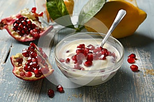 Delicious lemon and pomegranate dessert in the glass bowl