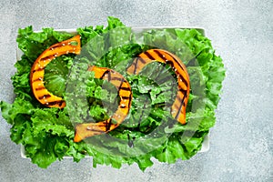 Delicious light salad of grilled pumpkin slices and lettuce