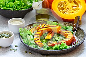Delicious light salad of grilled pumpkin slices and lettuce