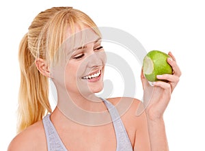 Delicious and light. Studio shot of an attractive young woman eating an apple isolated on white.