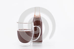 Delicious looking glass cup and bottle of chocolate milkshake: Selective focus and close up