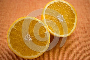 Delicious looking juicy halves of oranges on the table