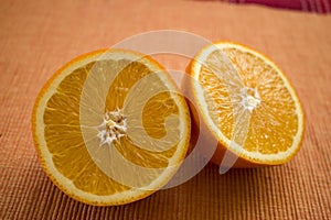 Delicious looking juicy halves of oranges on the table