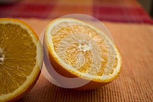 Delicious looking juicy halves of oranges on the table