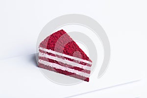Delicious looking layered red velvet cake slice, isolated on white