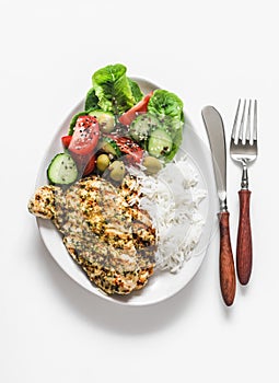 Delicious lunch - lime, cilantro, garlic olive oil marinated grilled chicken breast, basmati rice and fresh vegetable salad on a