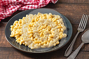 Delicious Mac n Cheese or macaroni and cheese on a black porcelain plate