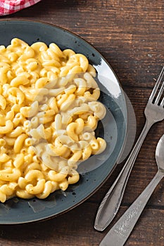 Delicious Mac n Cheese or macaroni and cheese on a black porcelain plate