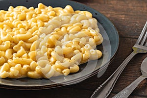 Delicious Mac n Cheese or macaroni and cheese on a black porcelain plate