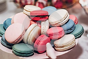 delicious macaroons close-up. candy bar at luxury wedding reception. exclusive expensive catering. table with modern desserts. sp