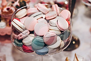 delicious macaroons close-up. candy bar at luxury wedding reception. exclusive expensive catering. table with modern desserts. sp