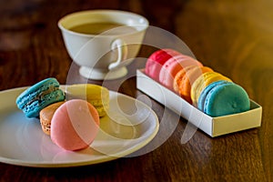 Delicious macaroons on the wooden table, with copy space