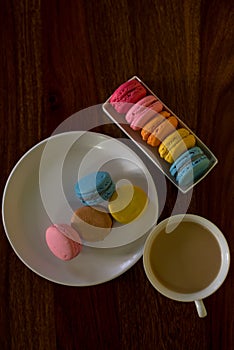 Delicious macaroons on the wooden table, with copy space