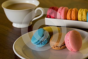 Delicious macaroons on the wooden table, with copy space