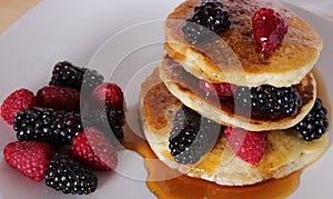 Delicious maple syrup pancakes with berries