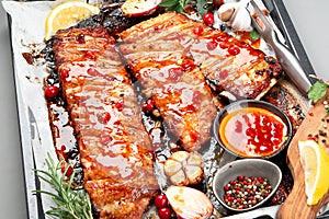 Delicious marinated grilled barbecue spare ribs with different sauces