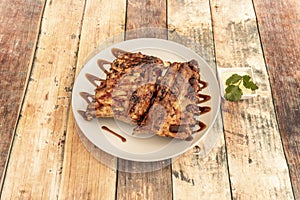 Delicious marinated and grilled pork ribs, served with barbecue