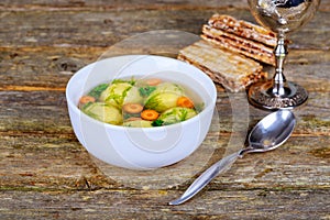 Delicious Matzoh ball soup with crackers wine and dill