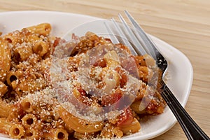 Delicious meal of elbow macaroni with pasta sauce and parmesan
