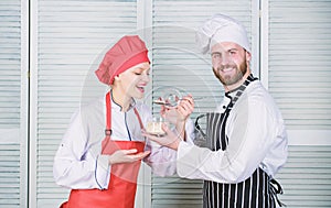 Delicious meal. Woman and bearded man cooking together. Couple compete in culinary. Try ingredients before cook