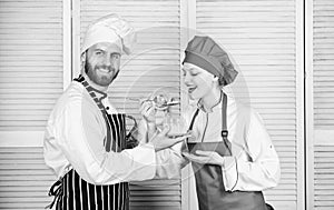 Delicious meal. Woman and bearded man cooking together. Couple compete in culinary. Try ingredients before cook