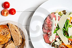 Delicious meat beef steak cooked at medium rare roast and served with fresh vegetable salad and cheese