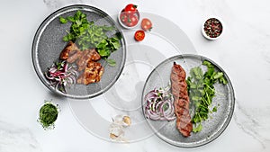 Delicious meat kebab with fresh vegetable. Grilled meat kebabs, vegetables on a marble table