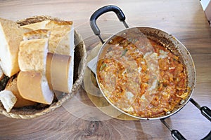 Delicious menemen served with fresh bread in a cozy eatery photo