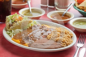 Delicious Mexican  taco with lettuce, rice and salsas  in a plate photo