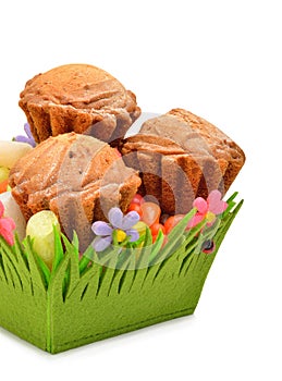 Delicious muffins, colorful caramels in the green basket
