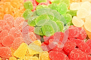 Delicious multi-colored fruit marmalade. unhealthy bright candies in bulk. different jelly photo close. tasty sweets in the candy