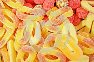 Delicious multi-colored fruit marmalade. unhealthy bright candies in bulk. different jelly photo close. tasty sweets in the candy