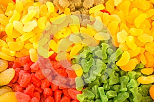 Delicious multi-colored fruit marmalade. unhealthy bright candies in bulk. different jelly photo close. tasty sweets in the candy