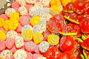 Delicious multi-colored fruit marmalade. unhealthy bright candies in bulk. different jelly photo close. tasty sweets in the candy