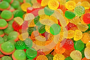 Delicious multi-colored fruit marmalade. unhealthy bright candies in bulk. different jelly photo close. tasty sweets in the candy