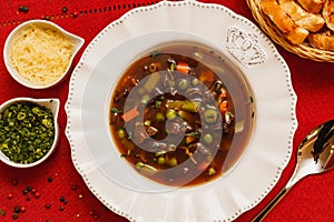 Delicious mushroom broth in wine sauce, mushroom soup in wine sauce, with wooden background, red fabric background, with toast,
