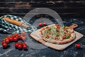 Delicious Neapolitan pizza on board with cherry tomatoes, free space for text