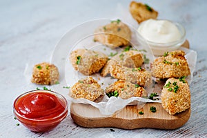 Delicious nuggets served on the board with two sauces